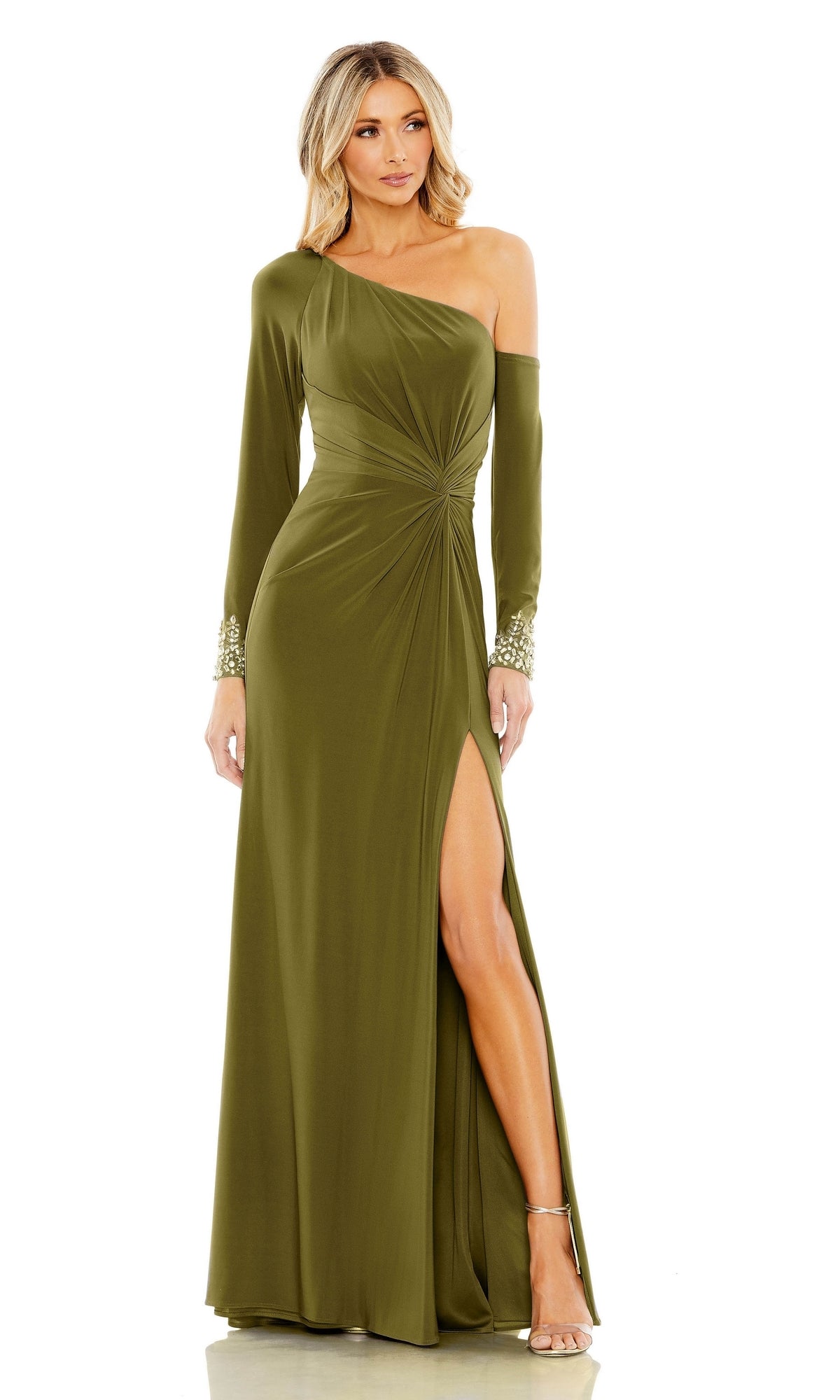 A woman models the Mac Duggal Long Formal Dress 12489—an olive green, one-shoulder gown with a thigh-high slit and beaded cuffs—posing against a plain background.